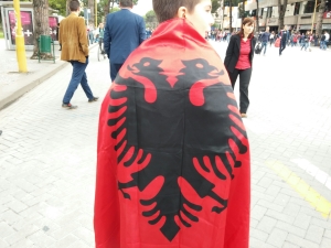 After a soccer win, Albanians adorned with excitement and their flag.